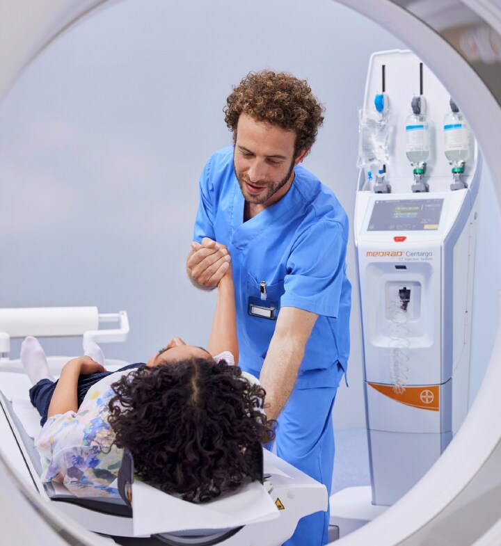 Radiographer preparing patient for scan