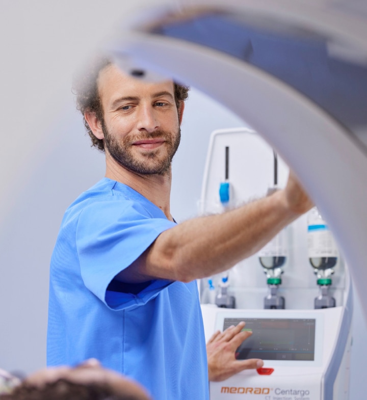 Radiographer preparing patient for scan